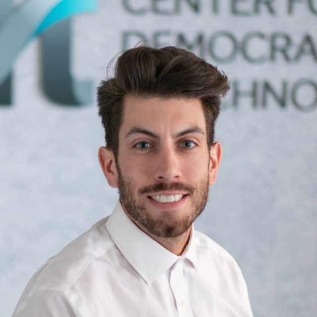 Tim Hoagland, wearing a white collared shirt smiling in front of a CDT logo.