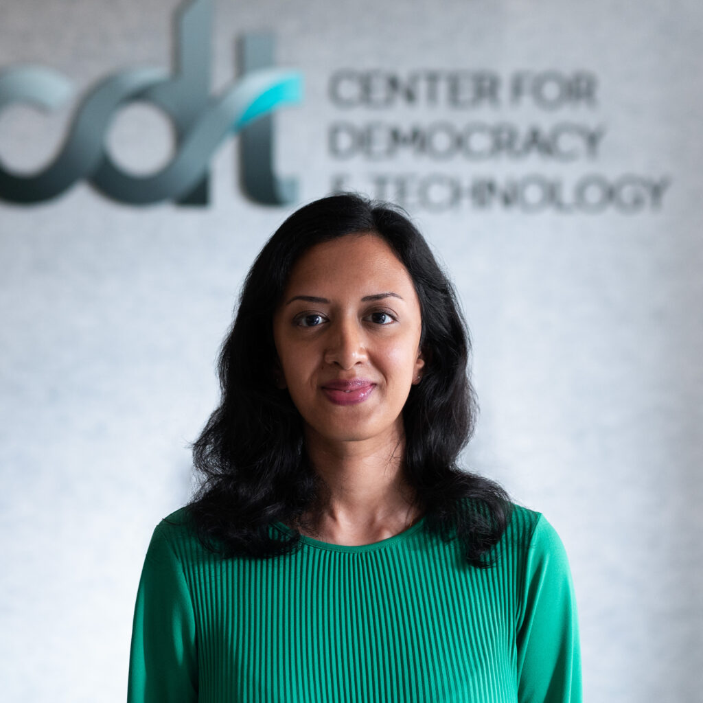 Ridhi Shetty, wearing a green top, smiling in front of a CDT logo.