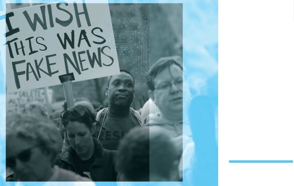 Image of protestors, including a sign that reads "I Wish This Was Fake News". Original image © Scott Olson / Getty Images.