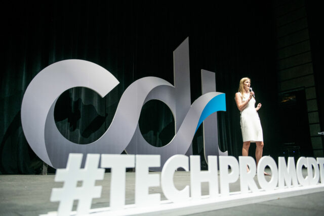 CDT President & CEO Alexandra Givens gives remarks from the main stage of CDT's 2022 Tech Prom. "#TECHPROM" in the foreground.