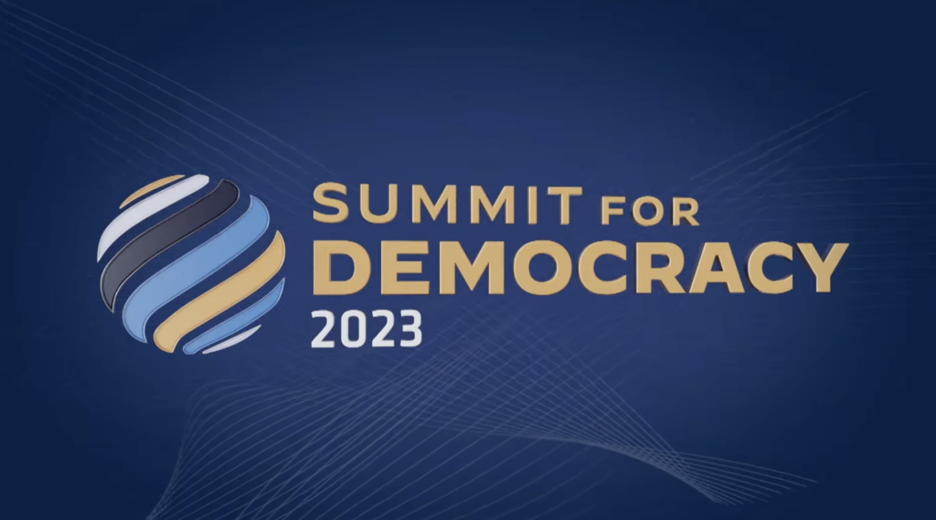 Screenshot from the U.S. Summit for Democracy 2023 livestream. Gold and white text on a blue background.
