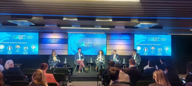 Photograph of five panellists, including CDT Europe’s Silvia Lorenzo Perez, at the panel "Cyber Mercenaries: The Search for Policy Solutions" in the context of the European Cyber Agora.