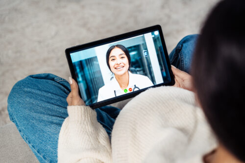 Pregnant woman on ipad.