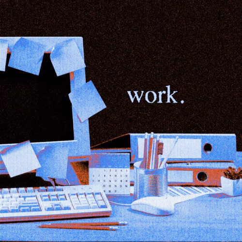 A stylized office workspace with a monitor, keyboard, notes, and the word 