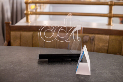 CDT logo on a clear light up sign sitting on a table.