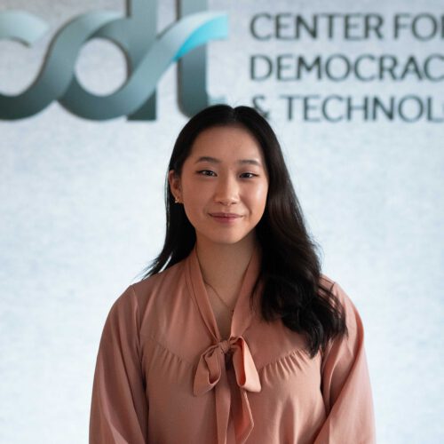 Sabrina Shih, smiling in front of a CDT logo, wearing a light-colored blouse.