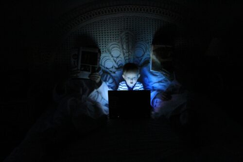 Child hiding under the covers.