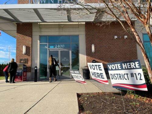 A photo of voters arriving at a polling place