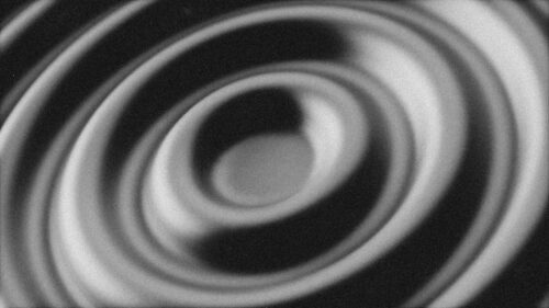 Illustration of concentric circles of light and shadow, in grayscale.