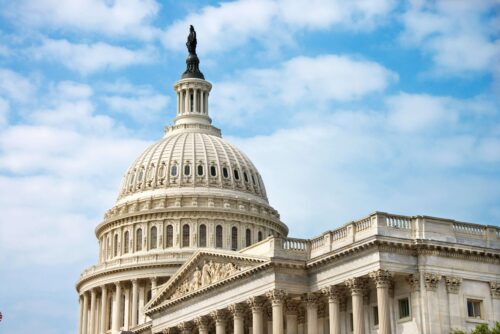 The U.S. Capitol Building in profile, including the dome and Statute of Freedom.
