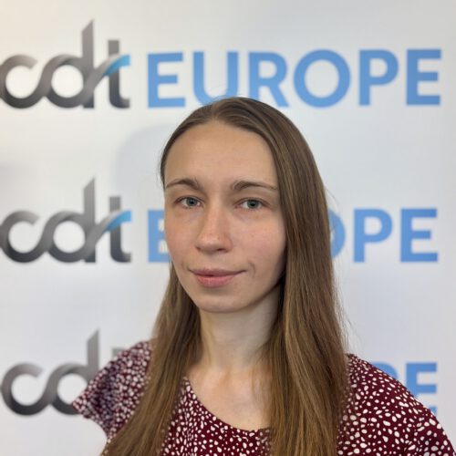 Svetlana Knyazeva standing in front of the CDT Europe logo banner