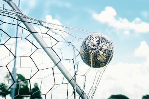 Soccer ball inside a goal.
