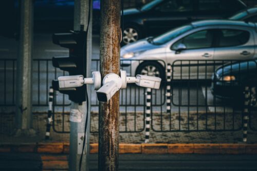Image of surveillance cameras attached to post.