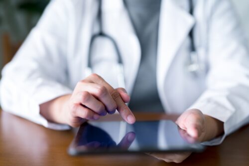 Doctor using ipad.