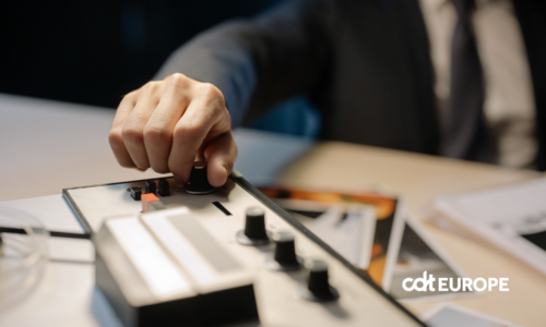A detective's hand adjusts knobs on a vintage tape recorder, suggesting investigation or espionage.